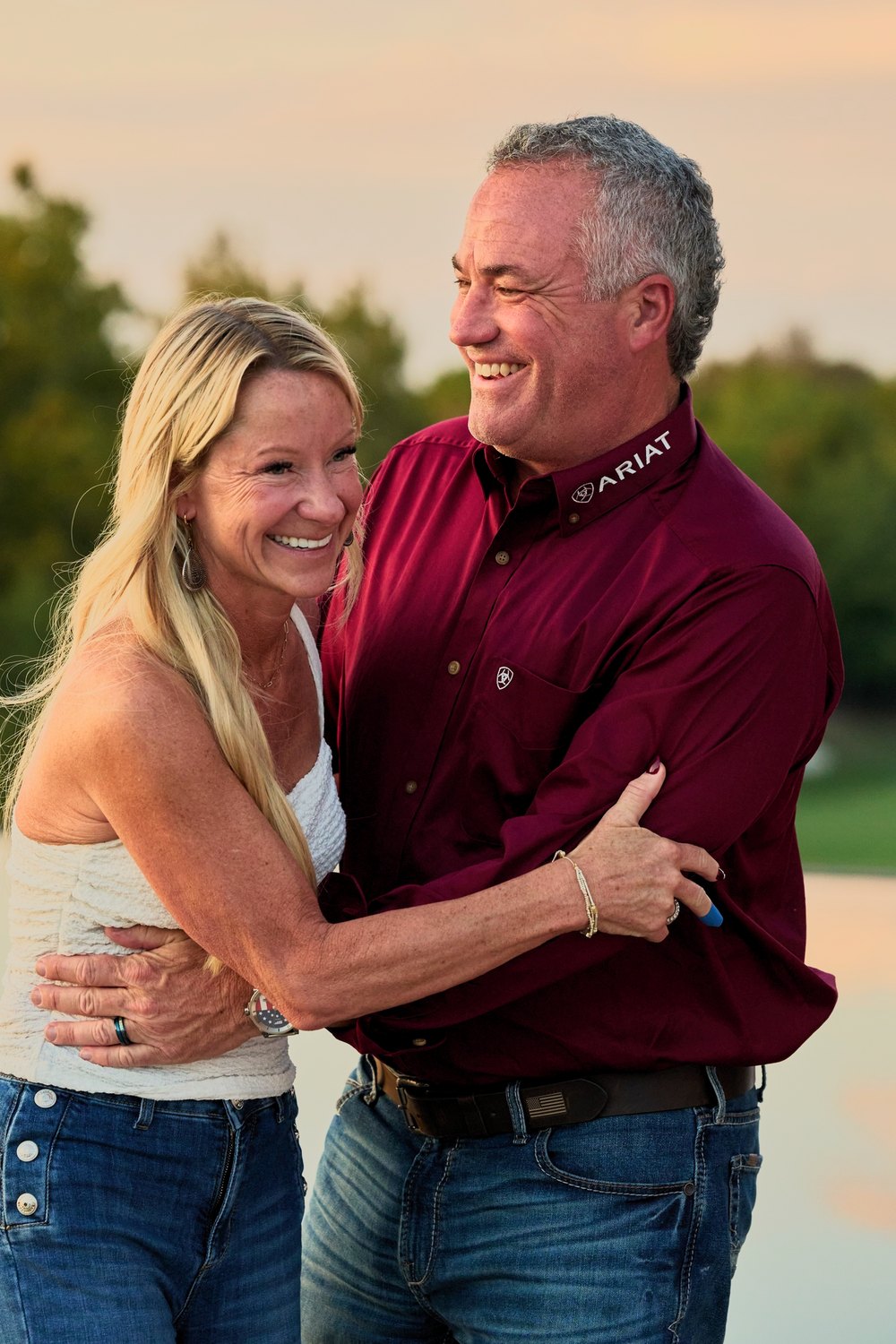A couple laughs together at golden hour
