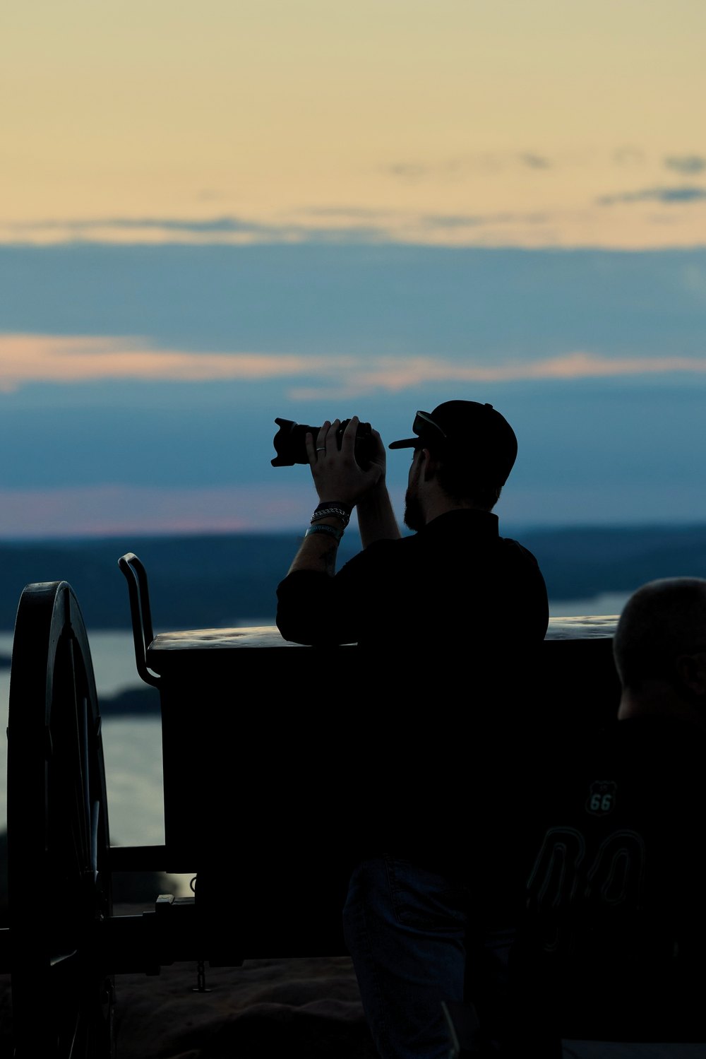 Two photographers silhouetted against the sunset
