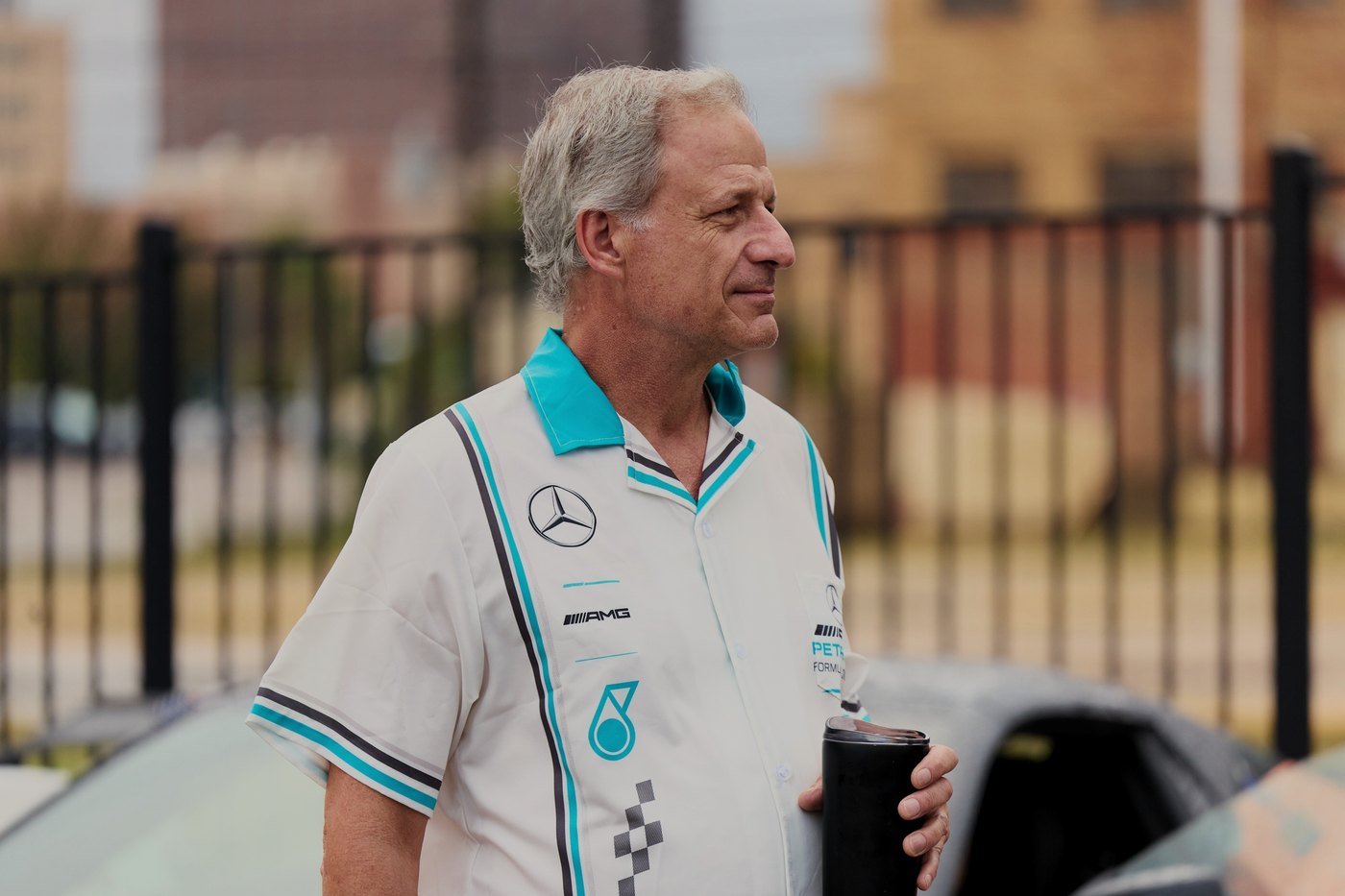 A driver in a Mercedes F1 team shirt at the morning start