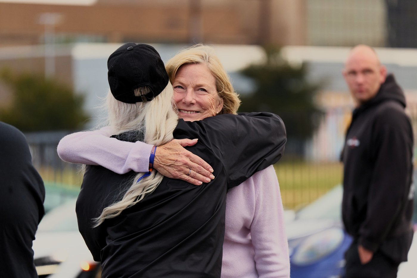 Two drivers hug in the paddock